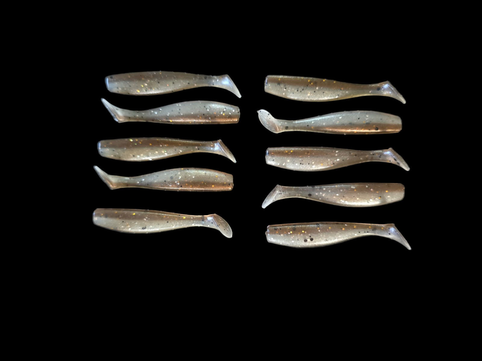 Set of metallic fish-shaped objects on a black background